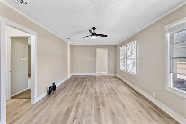 wooden floor in an empty room with a window
