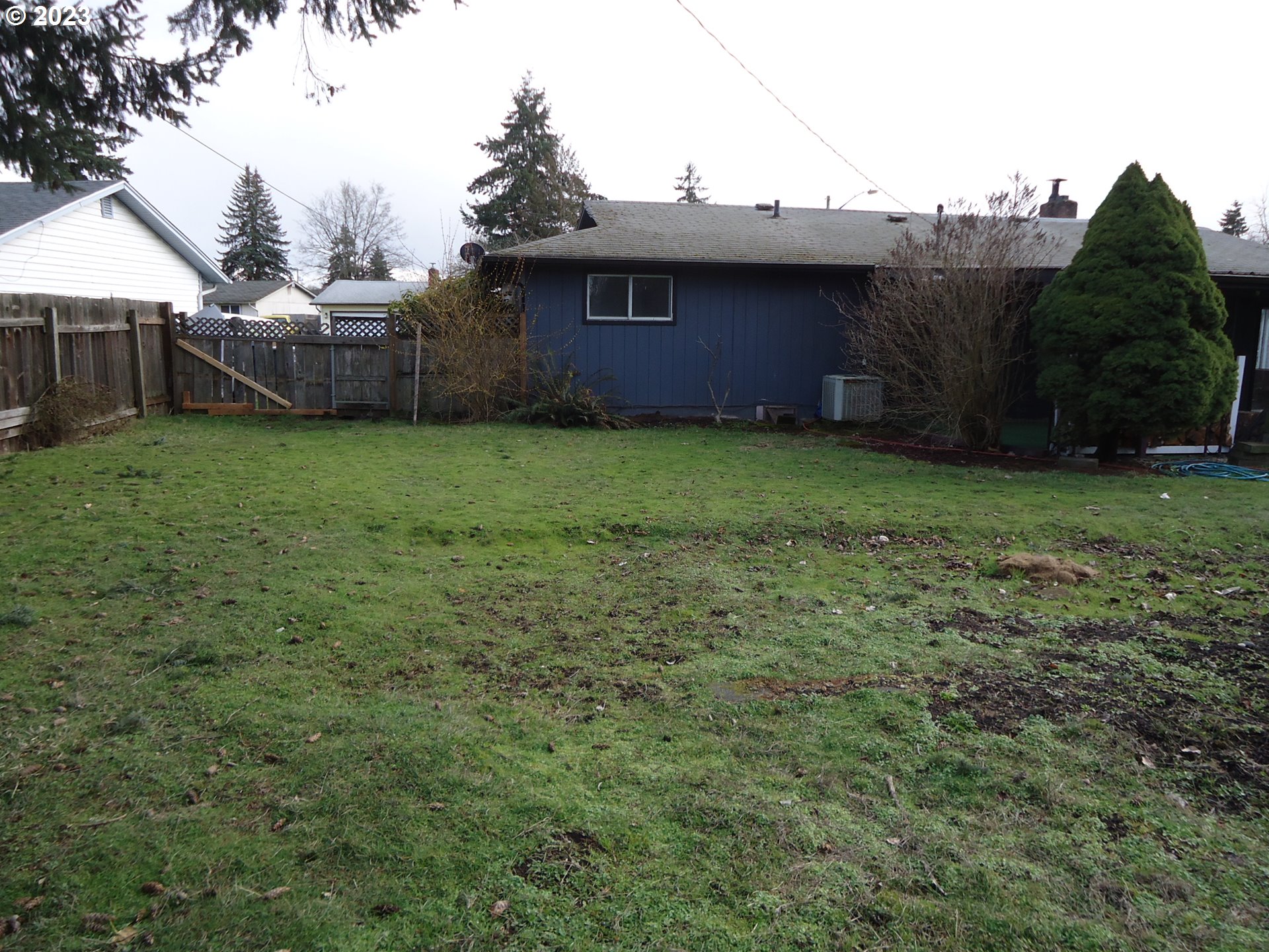 954 Quinalt Street Springfield, OR 97477 - Photo 16 of 18 a view of a house with a backyard and a garden