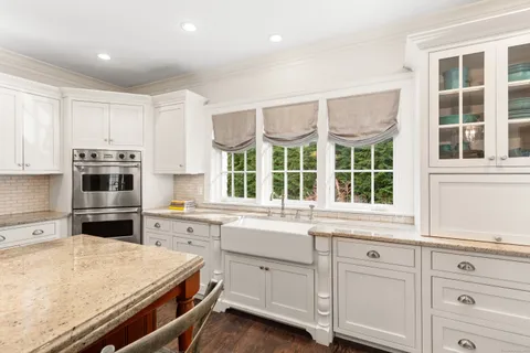 a kitchen with cabinets appliances and a window