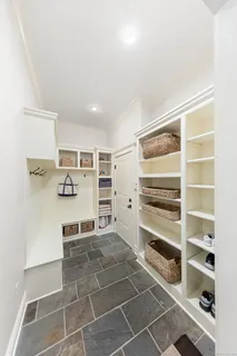 a view of kitchen with cabinets and window