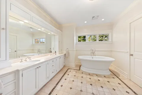 a bathroom with a double vanity sink mirror and toilet