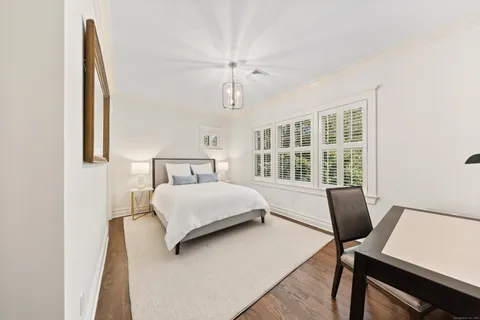 a bedroom with a bed and a desk