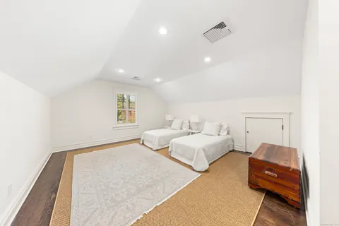 a spacious bedroom with a bed and a couch