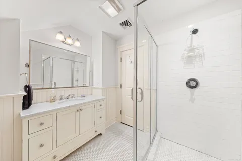 a bathroom with a double vanity sink mirror and