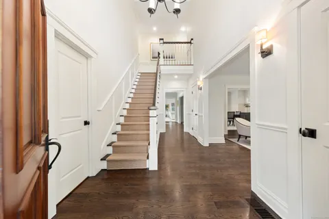 a view of a hallway with wooden floor and staircase