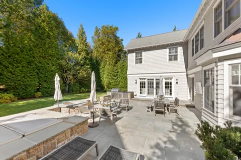 a view of a patio with lawn chairs floor to ceiling window and yard
