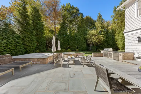 a view of backyard with seating area and trees