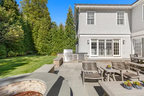 a view of a patio with table and chairs and potted plants