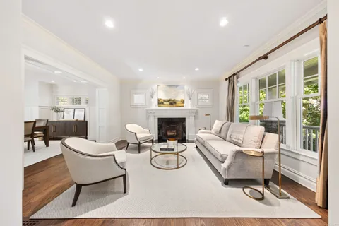 a living room with furniture a fireplace and a table