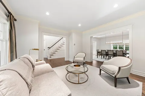 a living room with furniture a couch and large window