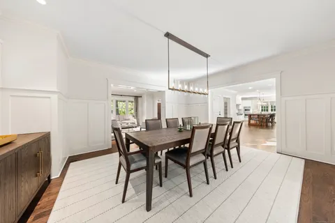 a dining room with furniture and wooden floor