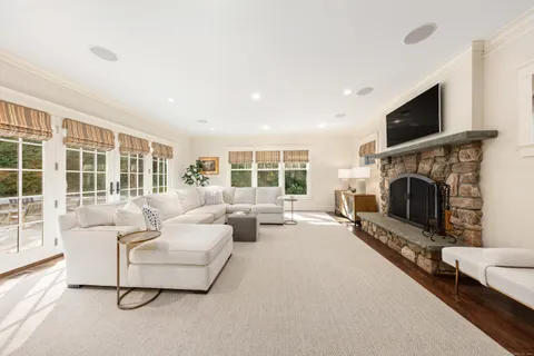a living room with furniture flat screen tv and a fireplace