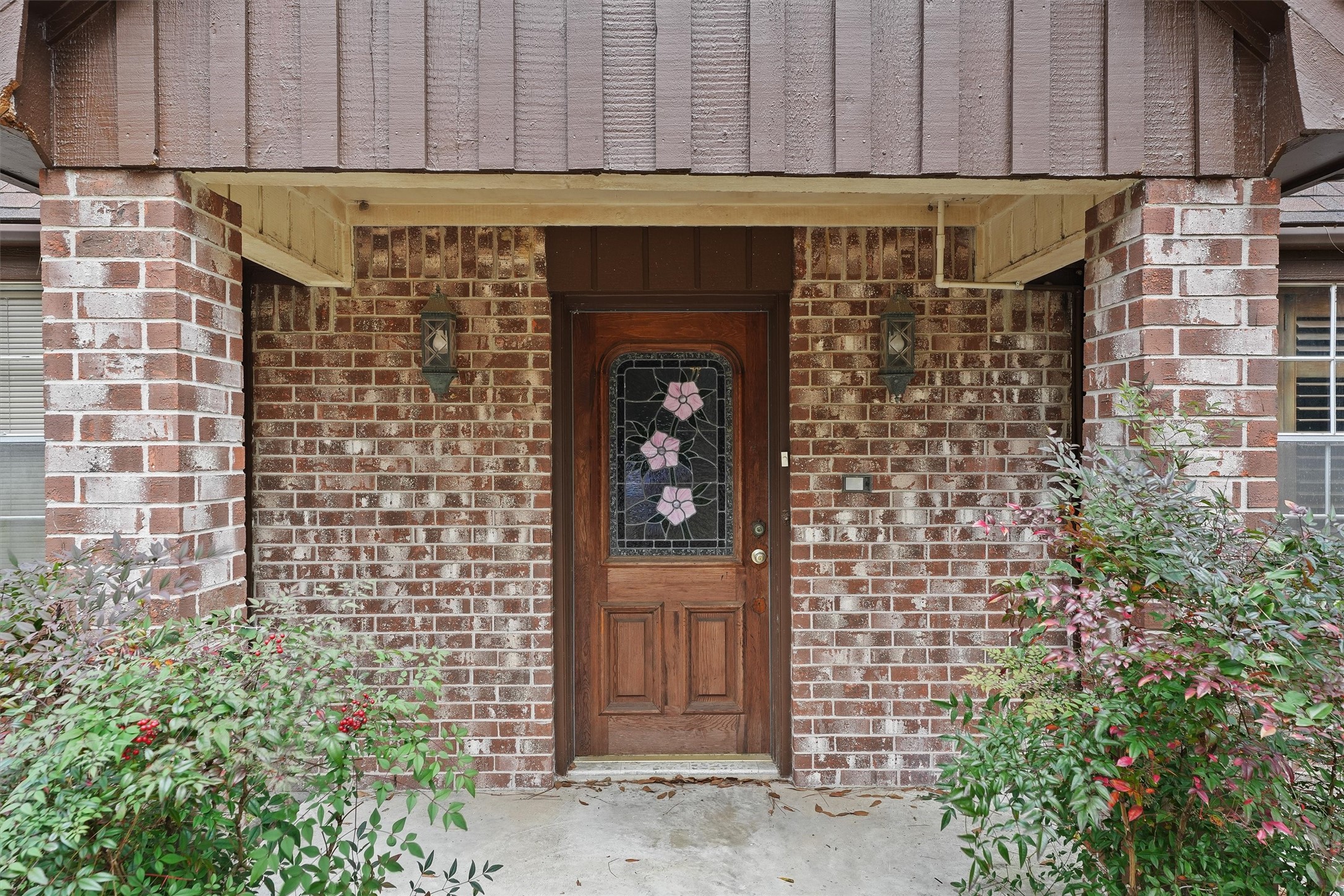 31926 Dobbin-Huffsmith Road Magnolia, TX 77354 - Photo 5 of 47 a front view of a building with glass door and brick wall