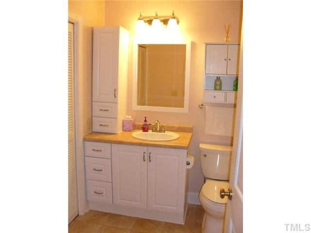 4400 Pickwick Drive Raleigh, NC 27613 - Photo 4 of 12 Hall bathroom udpated with new cabinetry, countertops, and tile flooring.