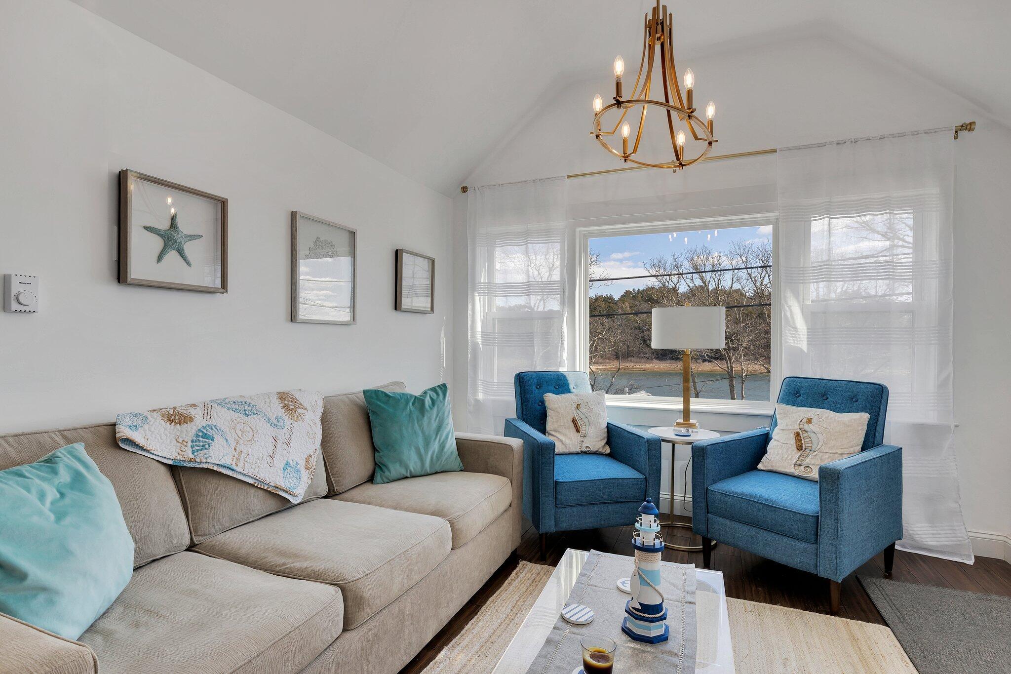 7 G Hideaway Road Buzzards Bay, MA 02532 - Photo 4 of 24 a living room with furniture a chandelier and a dining table