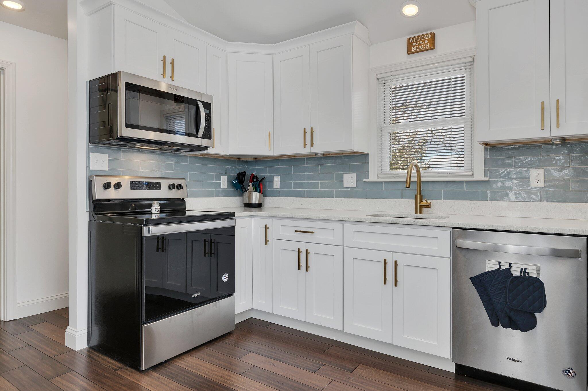 7 G Hideaway Road Buzzards Bay, MA 02532 - Photo 9 of 24 a kitchen with cabinets stainless steel appliances a sink and a microwave