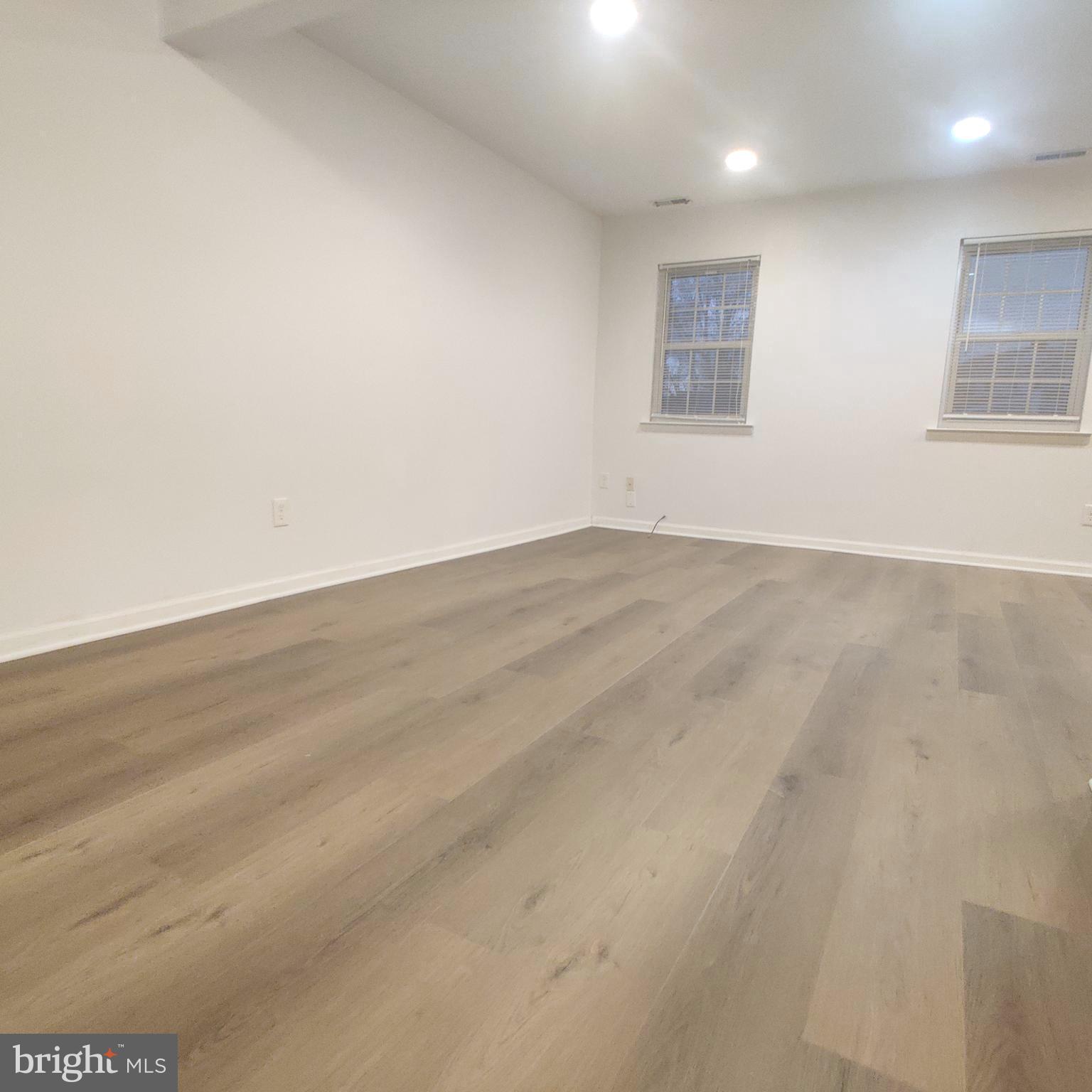 313 Carleton Lane Mount Laurel, NJ 08054 - Photo 12 of 12 an empty room with wooden floor and windows