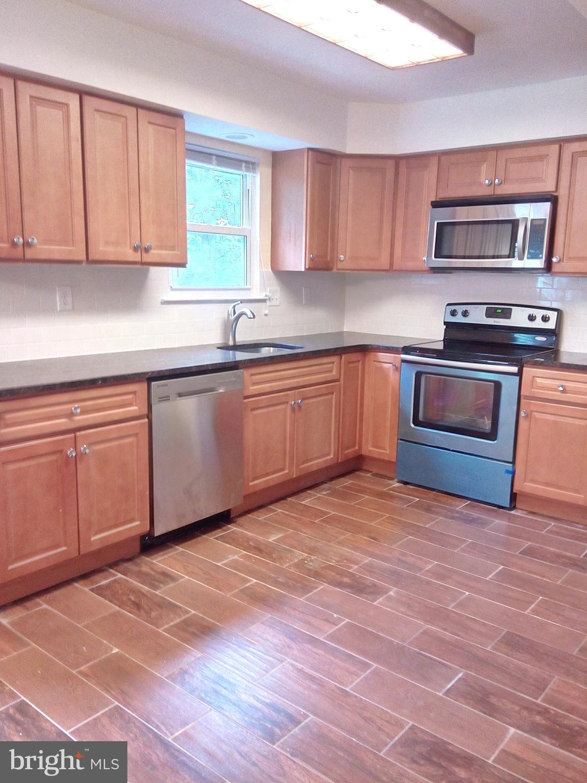 313 Carleton Lane Mount Laurel, NJ 08054 - Photo 2 of 12 a kitchen with stainless steel appliances granite countertop a stove top oven a sink and dishwasher