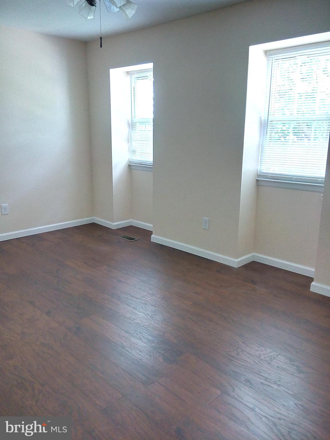 313 Carleton Lane Mount Laurel, NJ 08054 - Photo 3 of 12 an empty room with wooden floor and windows