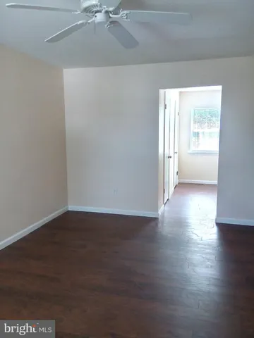 a view of an empty room and wooden floor