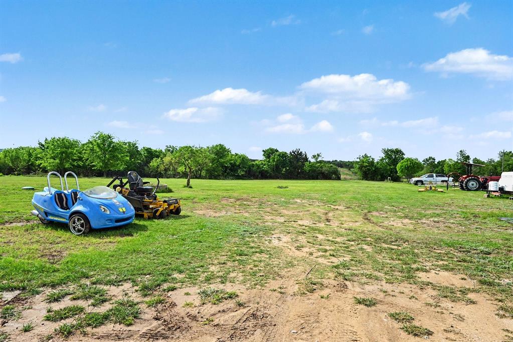 6694 Hutcheson Hill Road Springtown, TX 76082 - Photo 4 of 37 a view of a garden with houses