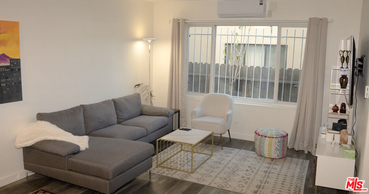 11670 Sunset Boulevard, Unit 104 Los Angeles, CA 90049 - Photo 3 of 11 a living room with furniture and a large window