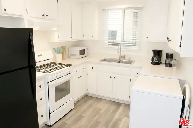 a kitchen with a sink stove and refrigerator