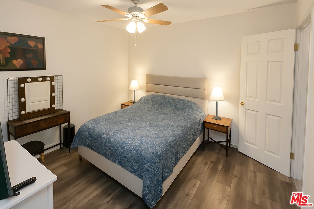 11670 Sunset Boulevard, Unit 104 Los Angeles, CA 90049 - Photo 8 of 11 a bedroom with a bed and a flat screen tv