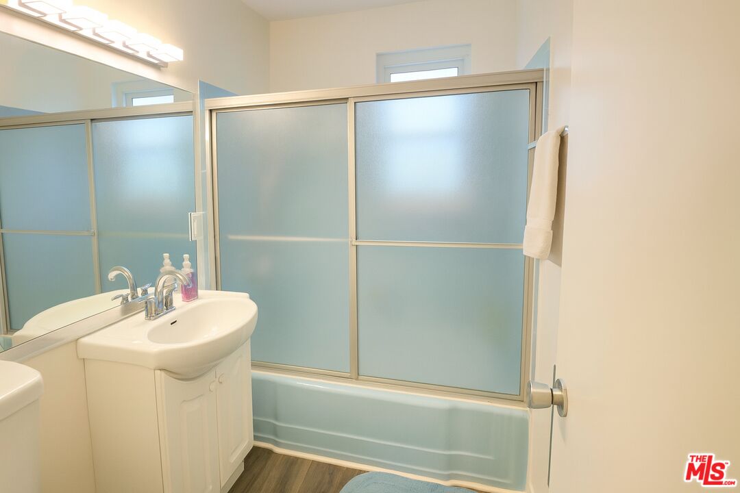 11670 Sunset Boulevard, Unit 104 Los Angeles, CA 90049 - Photo 9 of 11 a bathroom with a sink and a mirror
