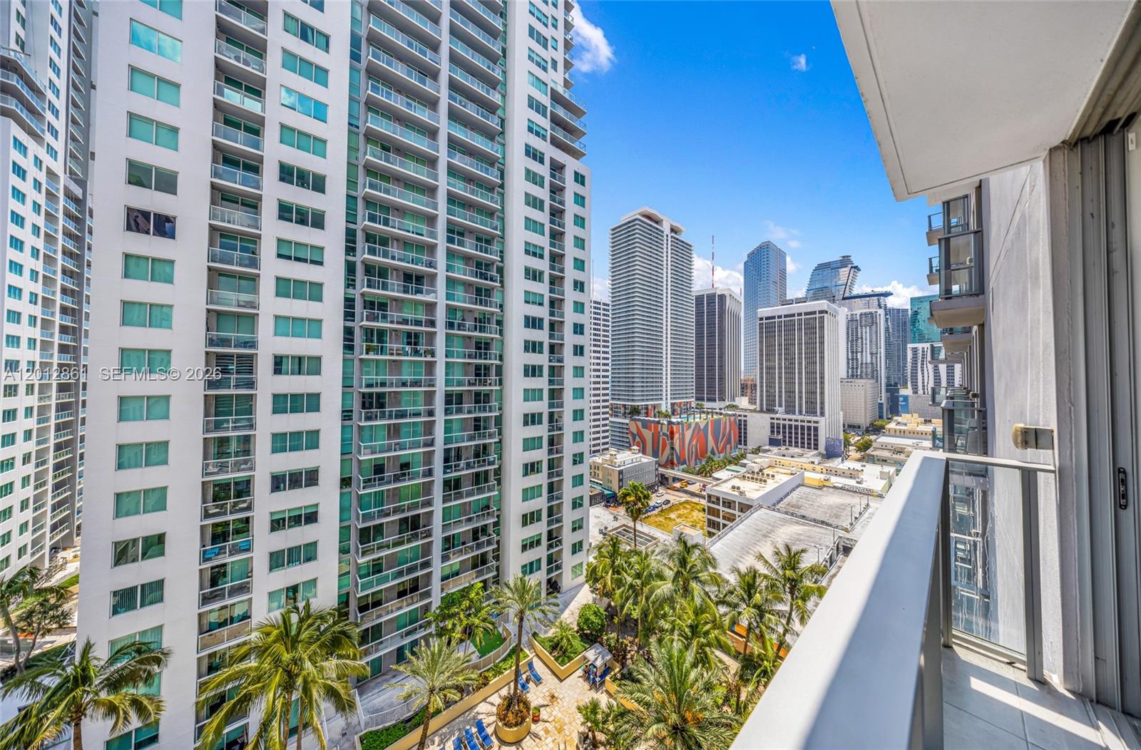 227 Northeast 2nd Street, Unit 1909 Miami, FL 33132 - Photo 6 of 18 a view of a balcony with chairs