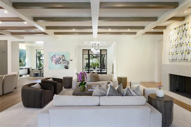 a living room with furniture a fireplace and a ceiling fan