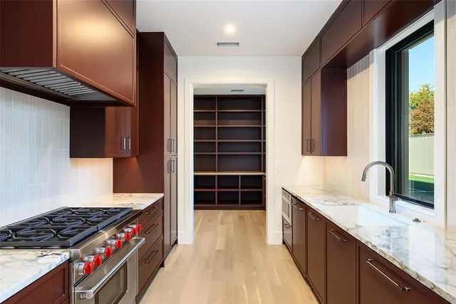 a kitchen with stainless steel appliances granite countertop a stove and a sink