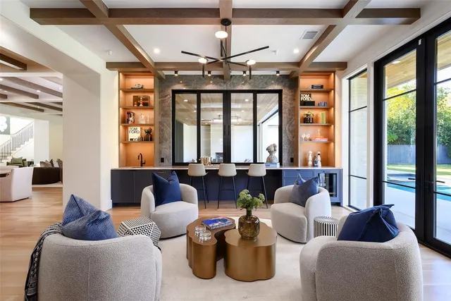 a living room with furniture and floor to ceiling windows