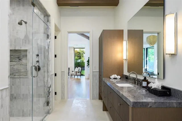 a bathroom with a granite countertop sink and a mirror