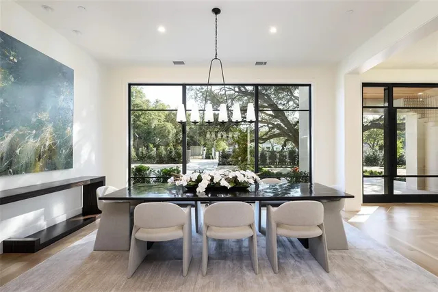 a dining room with furniture window and wooden floor