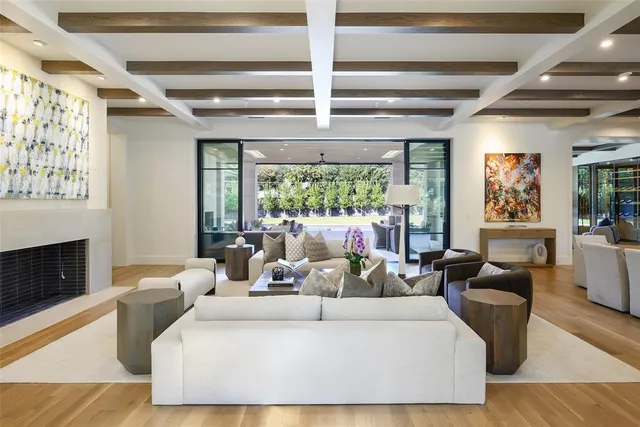 a living room with furniture large window and flat screen tv