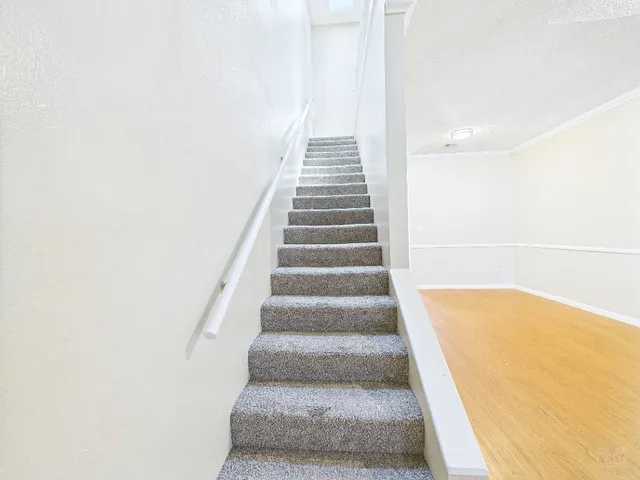 a view of a livingroom with stairs