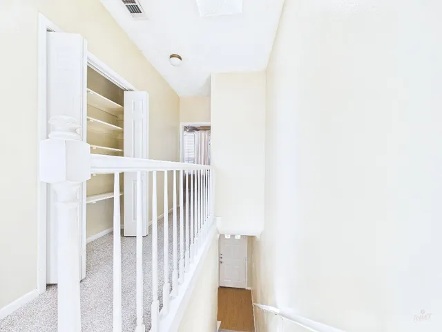 a view of a hallway with a white walls