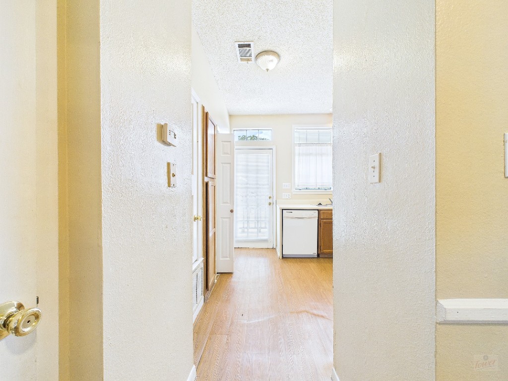 2300 Leon Street, Unit 204 Austin, TX 78705 - Photo 5 of 31 a view of a hallway with kitchen and dining room