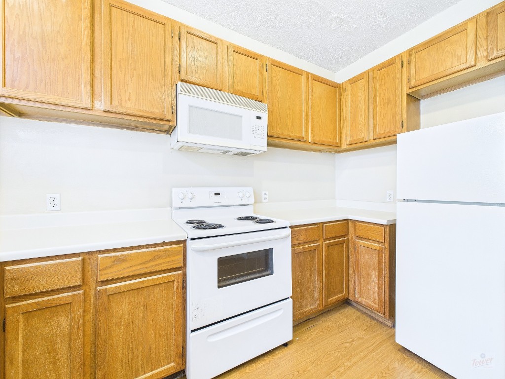 2300 Leon Street, Unit 204 Austin, TX 78705 - Photo 7 of 31 a kitchen with stainless steel appliances white cabinets and a refrigerator