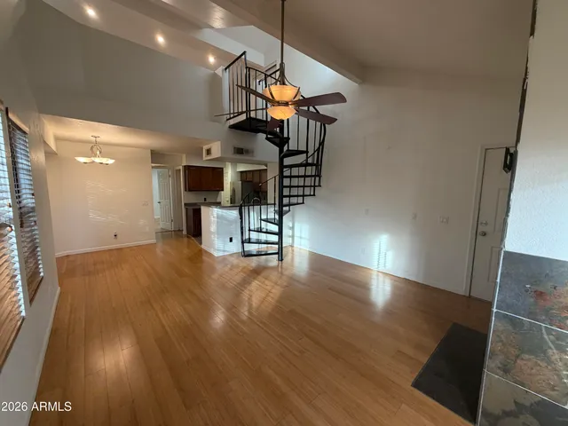 a view of a living room with wooden floor