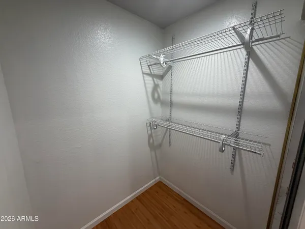 a view of a room with wooden floor and fan