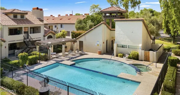 a view of a house with backyard water fountain and sitting area