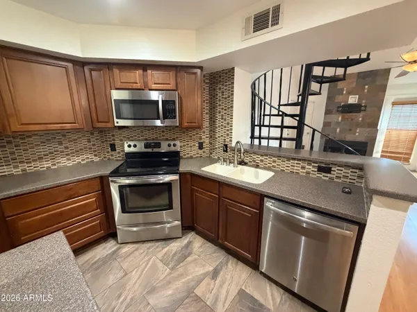 a kitchen with a sink stove and microwave
