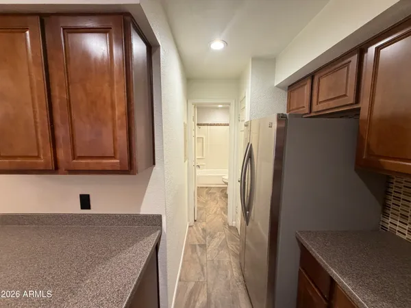 a kitchen with stainless steel appliances granite countertop a refrigerator and a sink