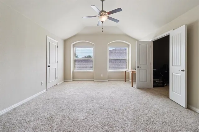 an empty room with windows and cabinet