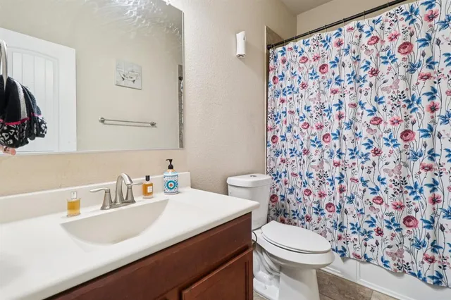 a bathroom with a sink toilet and a mirror