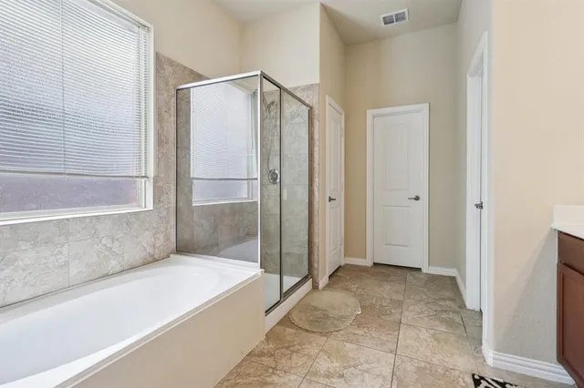 a bathroom with a bathtub and shower