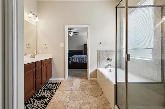 a en suite bathroom with a tub shower and sink