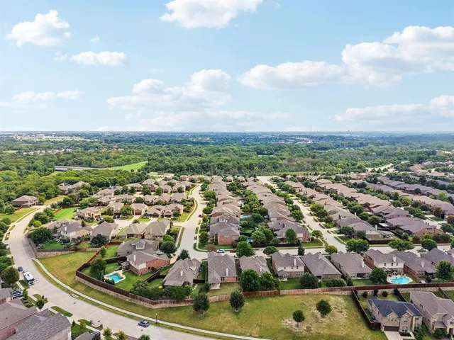 an aerial view of residential houses with outdoor space